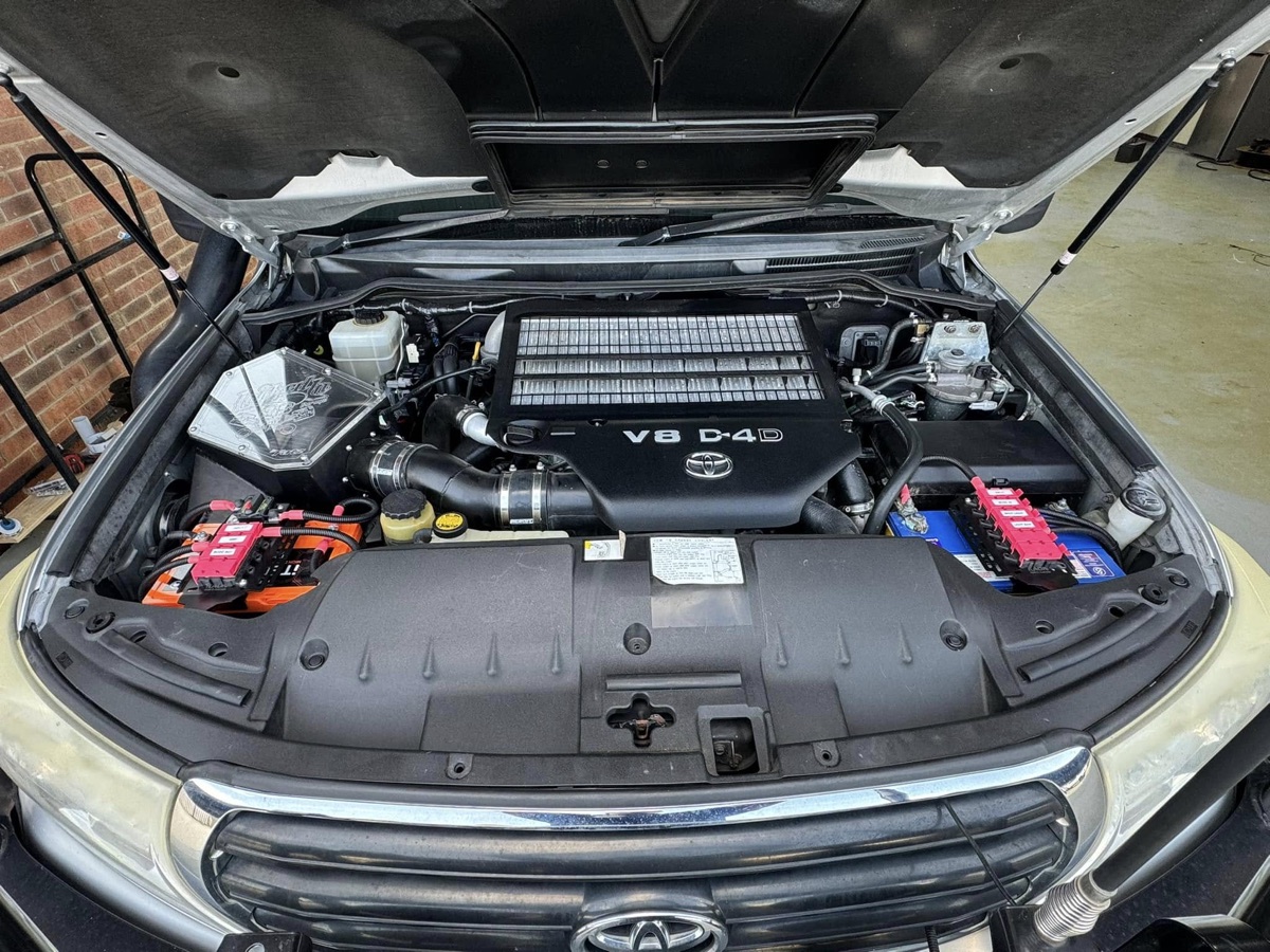 Toyota V8 diesel engine bay with an under-bonnet auxiliary battery and labelled fused distribution