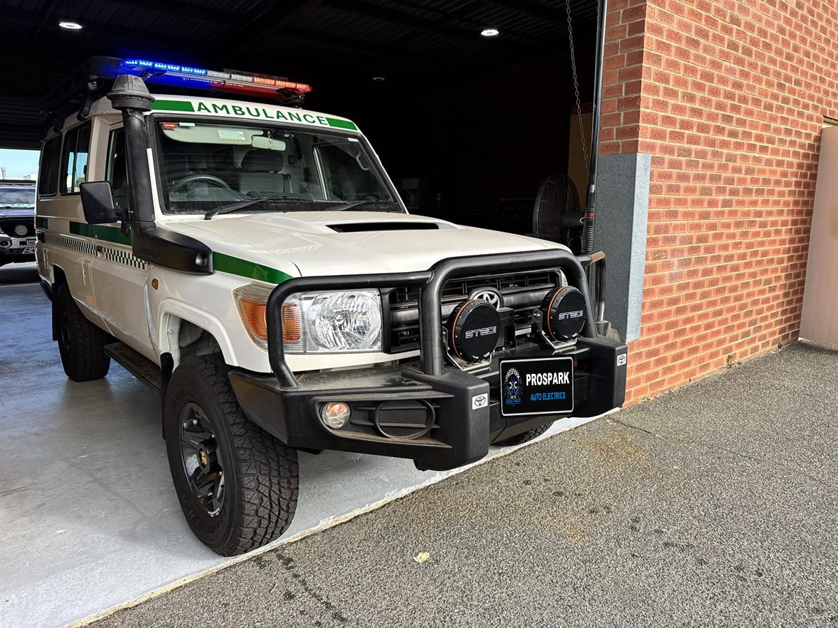 Ambulance LandCruiser fitted with STEDI driving lights and a roof light bar